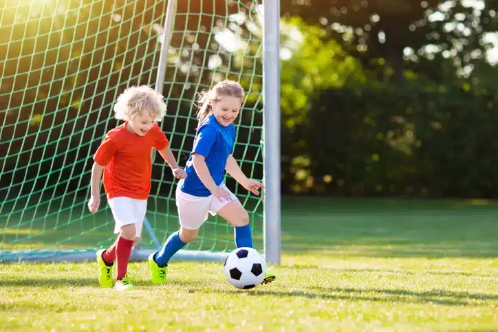 Kids play football. Child at soccer field. Kids play football. Child at soccer field.