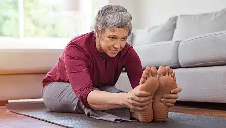 Mature woman doing yoga exercise at home Mature woman doing yoga exercise at home