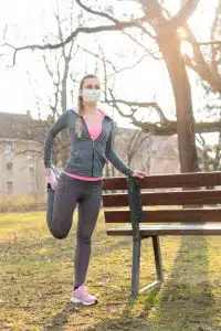 Woman during coronavirus crises exercising outdoors Woman during coronavirus crises exercising outdoors