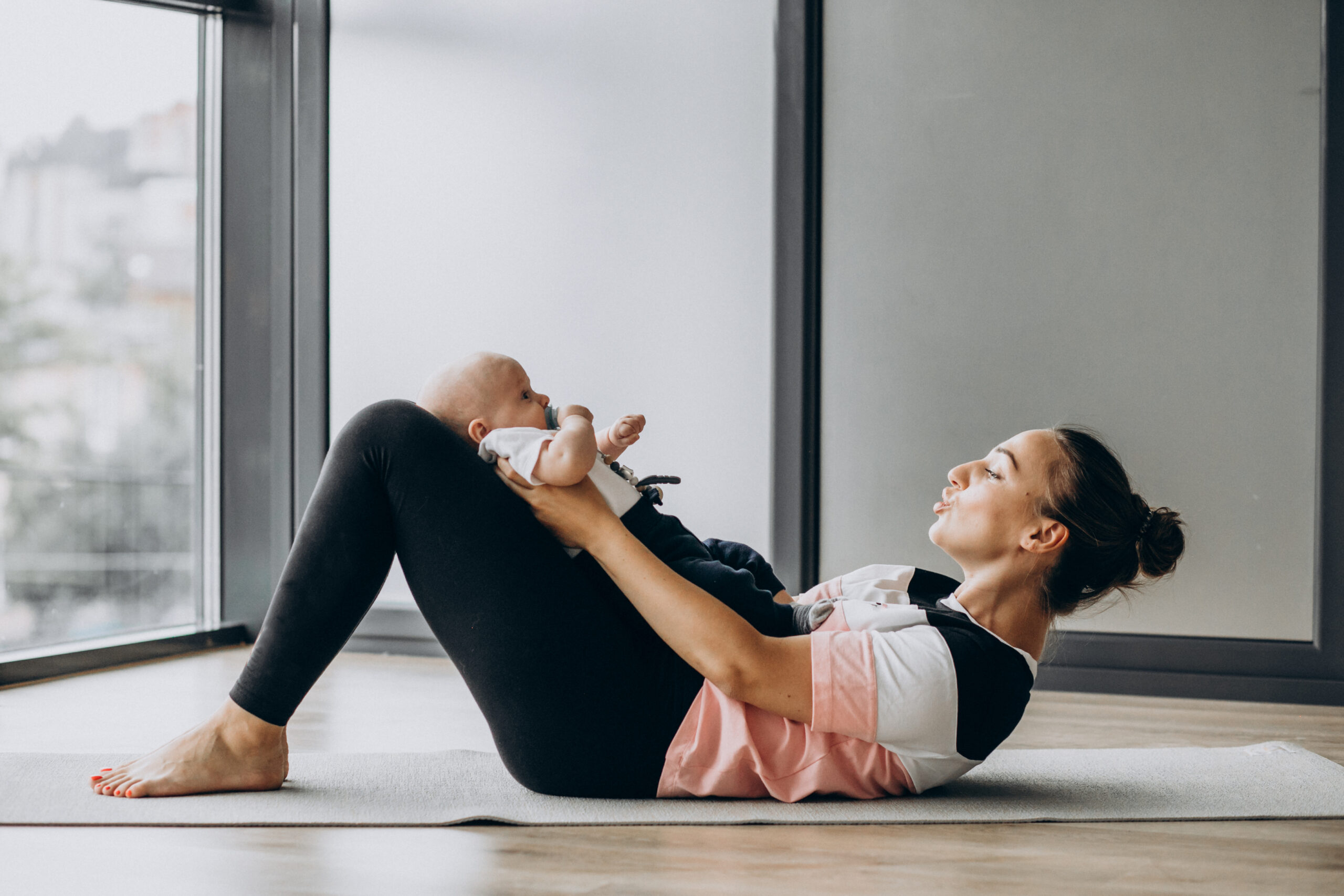 Woman with baby boy practice yoga Woman with baby boy practice yoga